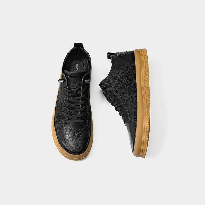 Men's black leather casual shoes with round toe and flat rubber sole on white background