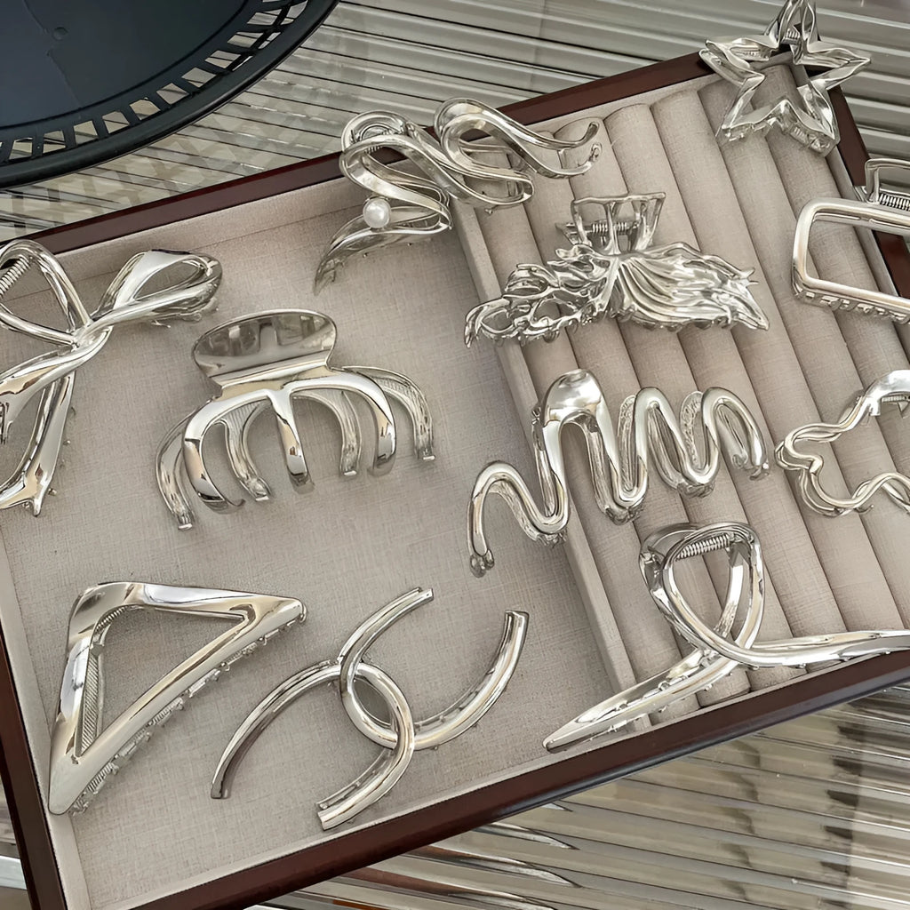 Silver electroplated metal hair claw barrette in a Korean-style design on white background