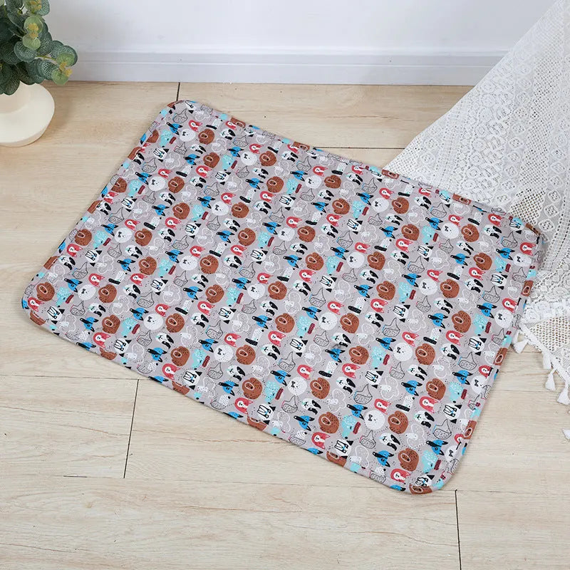 Washable waterproof pet urine pad in animal world pattern showing cloth surface and non-slip backing