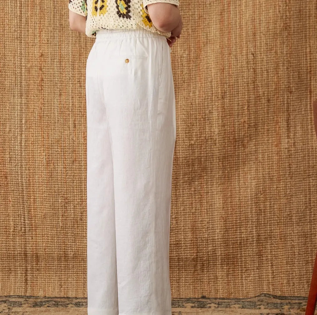 Linen high-waisted trousers with elasticated waist and lace trim in a straight-leg, loose fit.