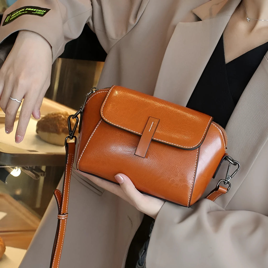 Women's brown oil wax cowhide shell-shaped crossbody messenger bag with visible stitching