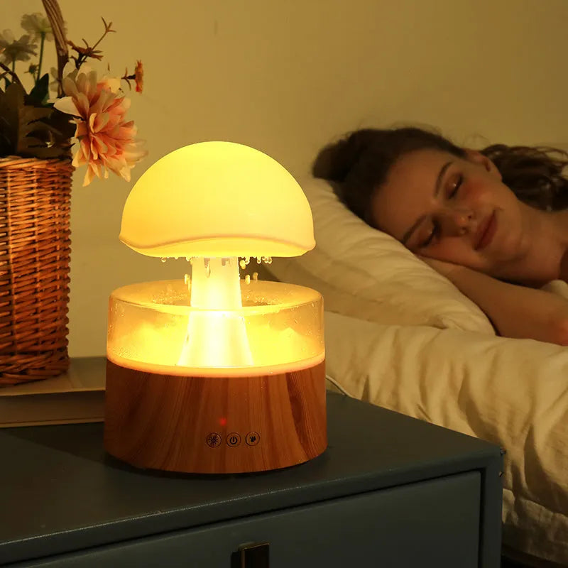White cloud-shaped humidifier and aroma diffuser with coloured lights and simulated raindrops