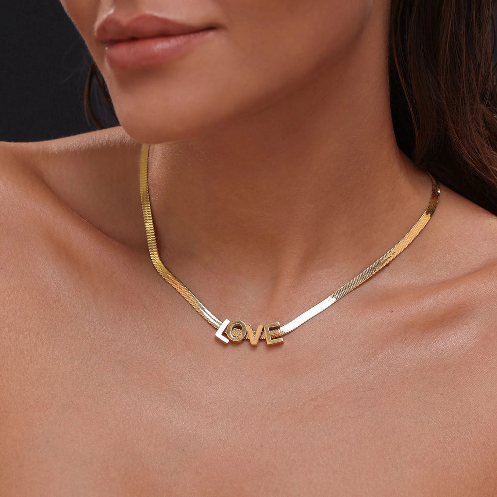 Gold titanium steel necklace with the letter 'A' pendant on a blade chain, 40.5cm long.