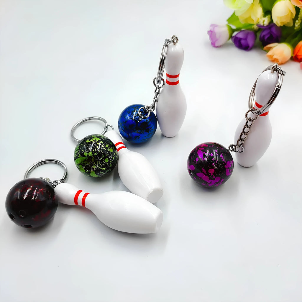 Miniature bowling ball keychain pendant in dark red, blue, purple, and green colours.