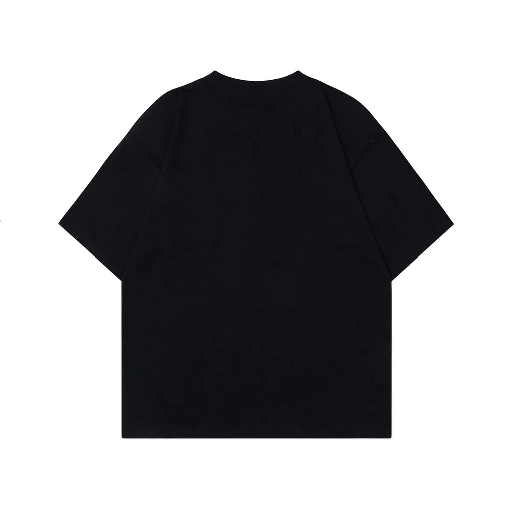 Man wearing a black loose-fit cotton t-shirt with a retro character design print on the front.