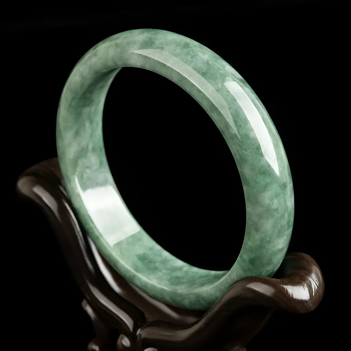 Women's natural emerald bean green ring bracelet on wrist, showing dark pea green beads and gift box.