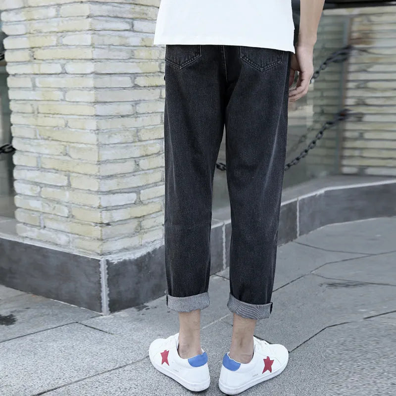 Men's black straight-leg jeans with loose fit and light straight leg opening on hanger