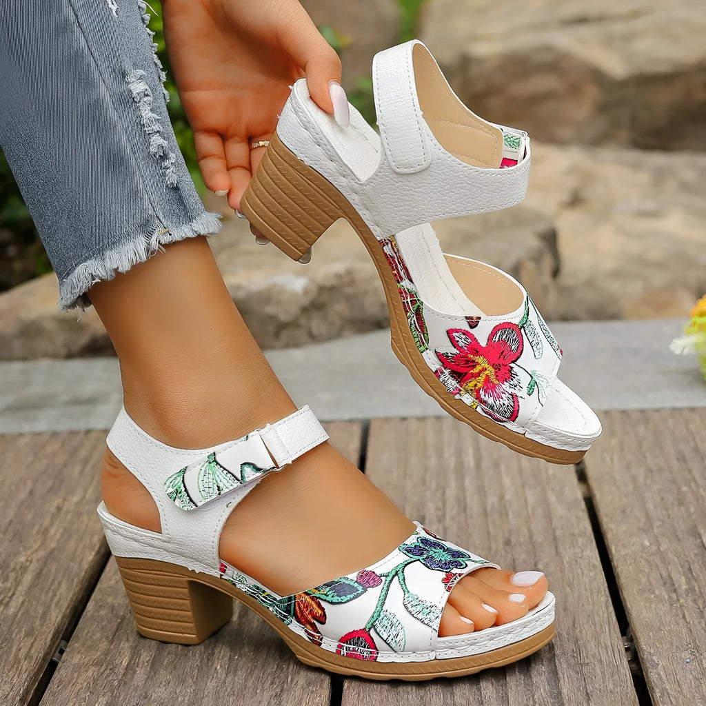 White women's high heel sandals with a velcro strap closure and rubber sole.