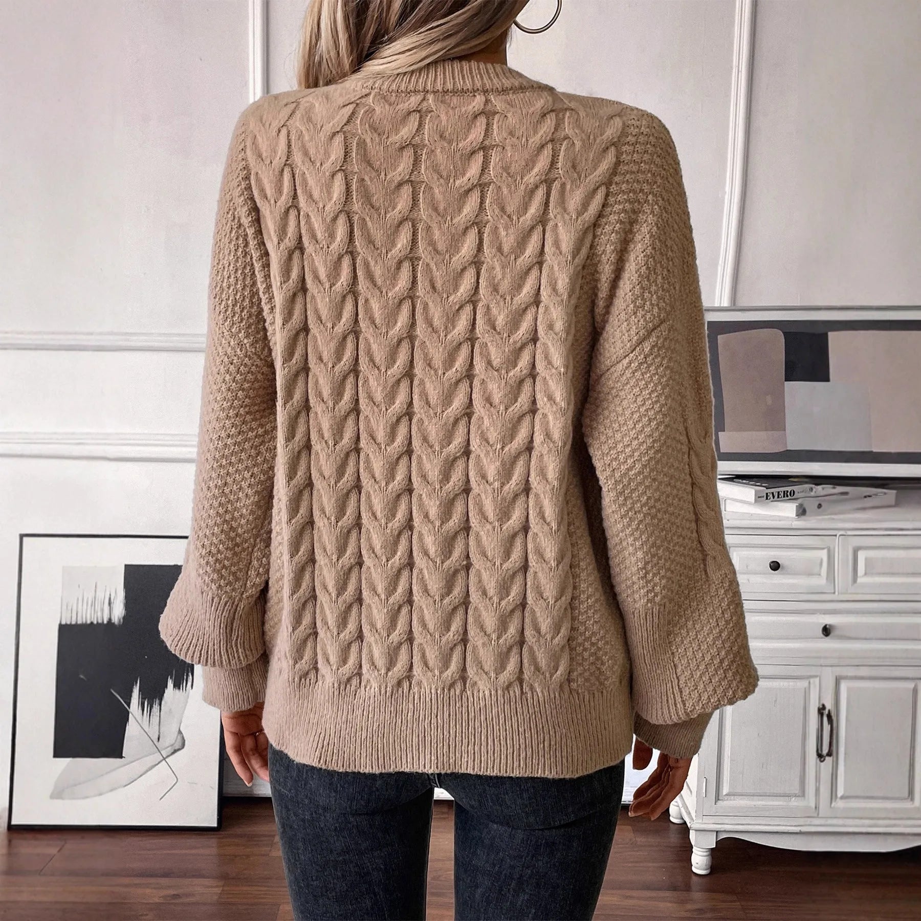 Women's beige casual sweater with twist detail and round neckline on hanger