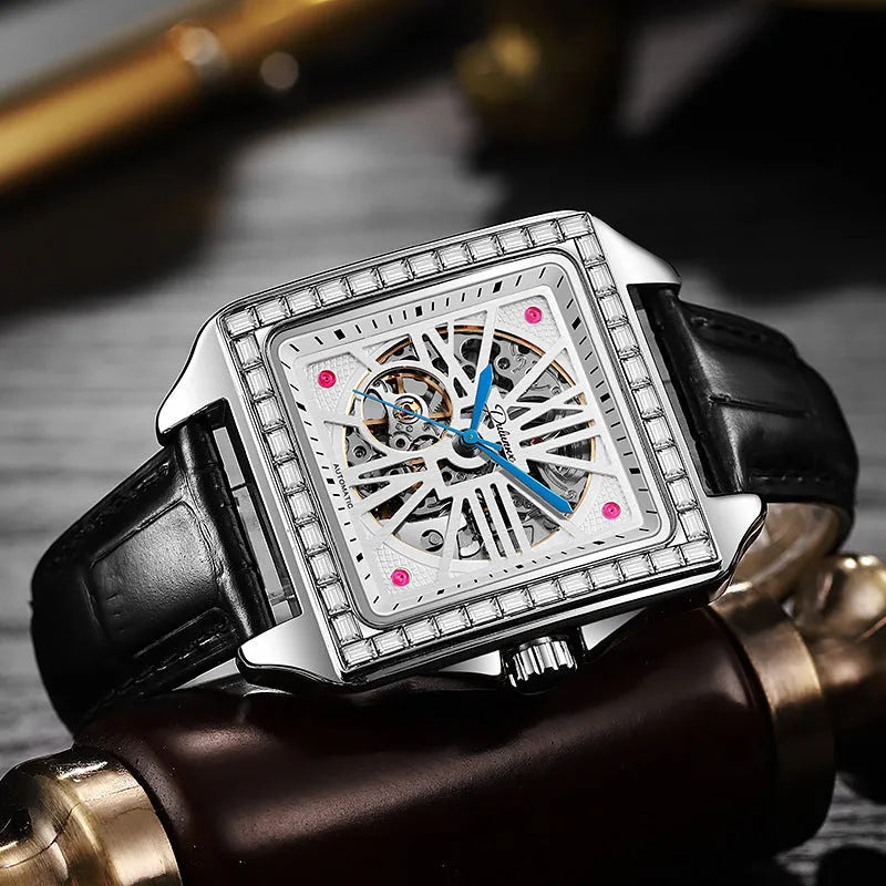 Square automatic watch for men with diamond detailing on a black leather strap.