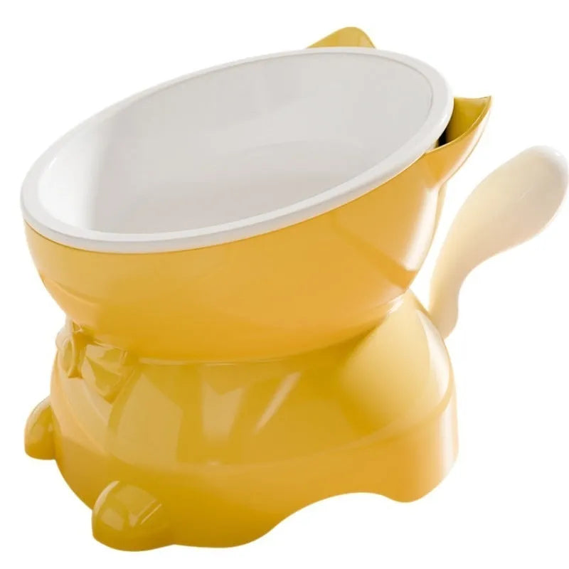 A slanted stainless steel cat bowl in yellow, shown from a side angle on a plain surface.