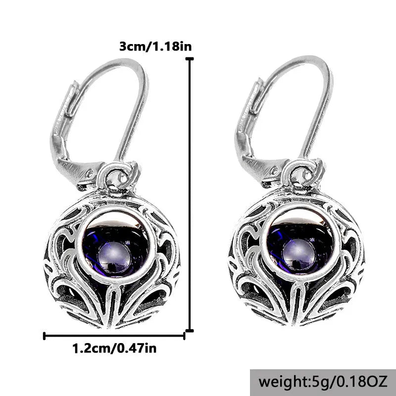 Silver geometric pendant earrings with vintage engraving and blue gemstone, shown from front view