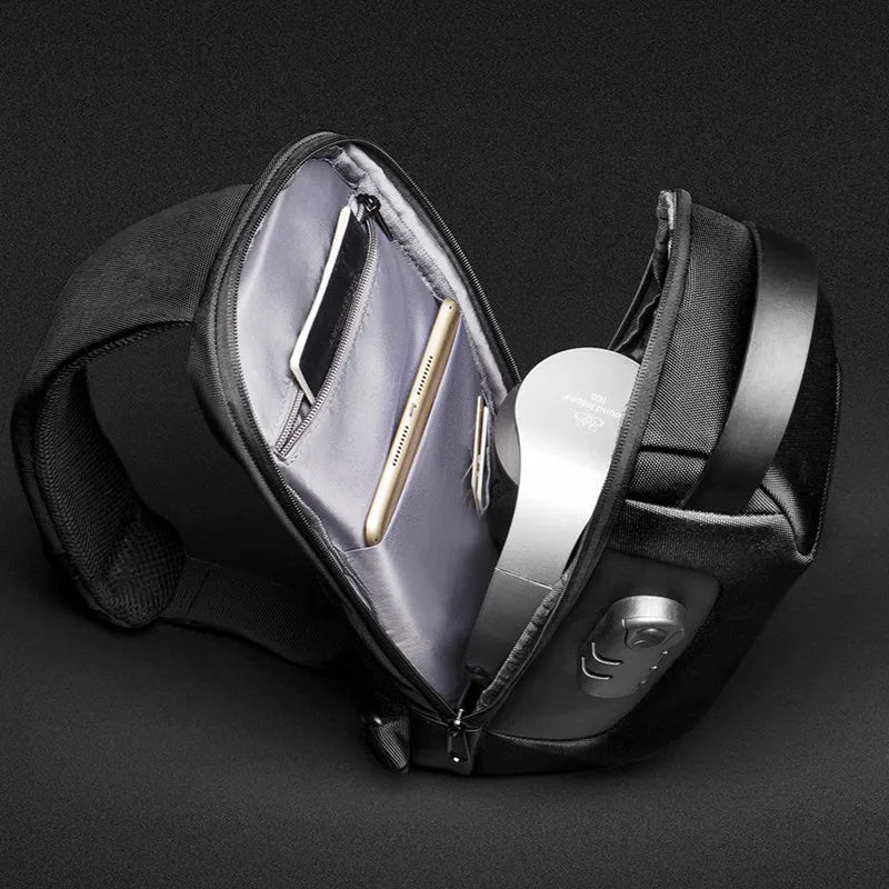 Men's black Oxford cloth crossbody bag showing front zipper and shoulder strap, with internal phone and laptop pockets visible.