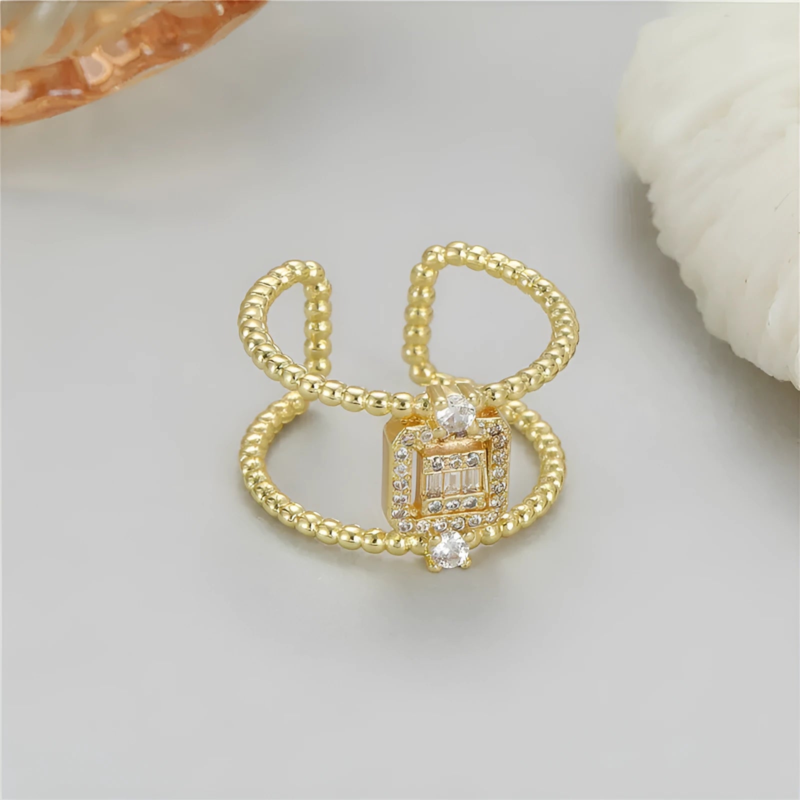 Copper open ring with 14K copper-plated gold finish and adjustable U-shaped asymmetric design
