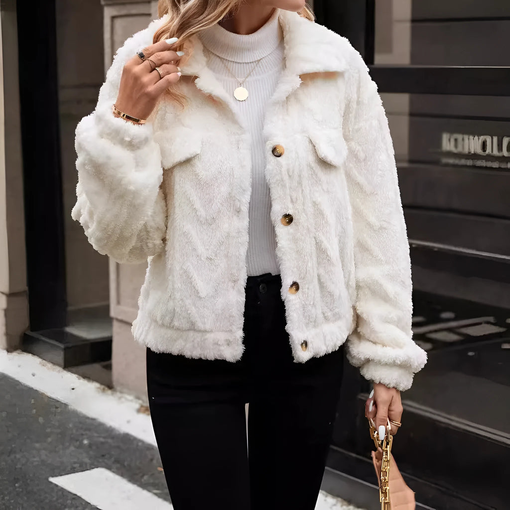 Ivory White women's plush button-front cardigan on a hanger