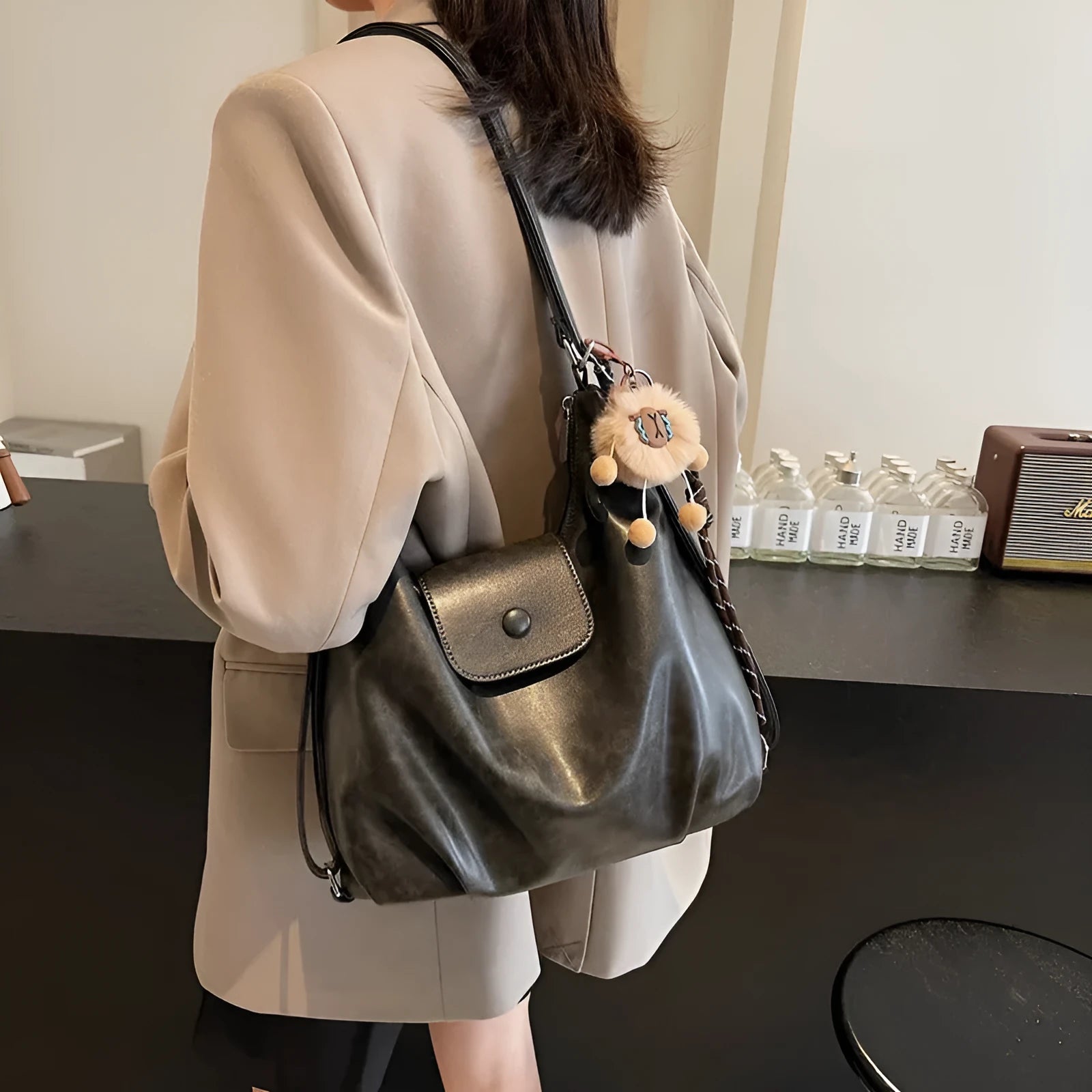 Brown textured PU one-shoulder bag with single strap showing internal phone compartment and horizontal organisation