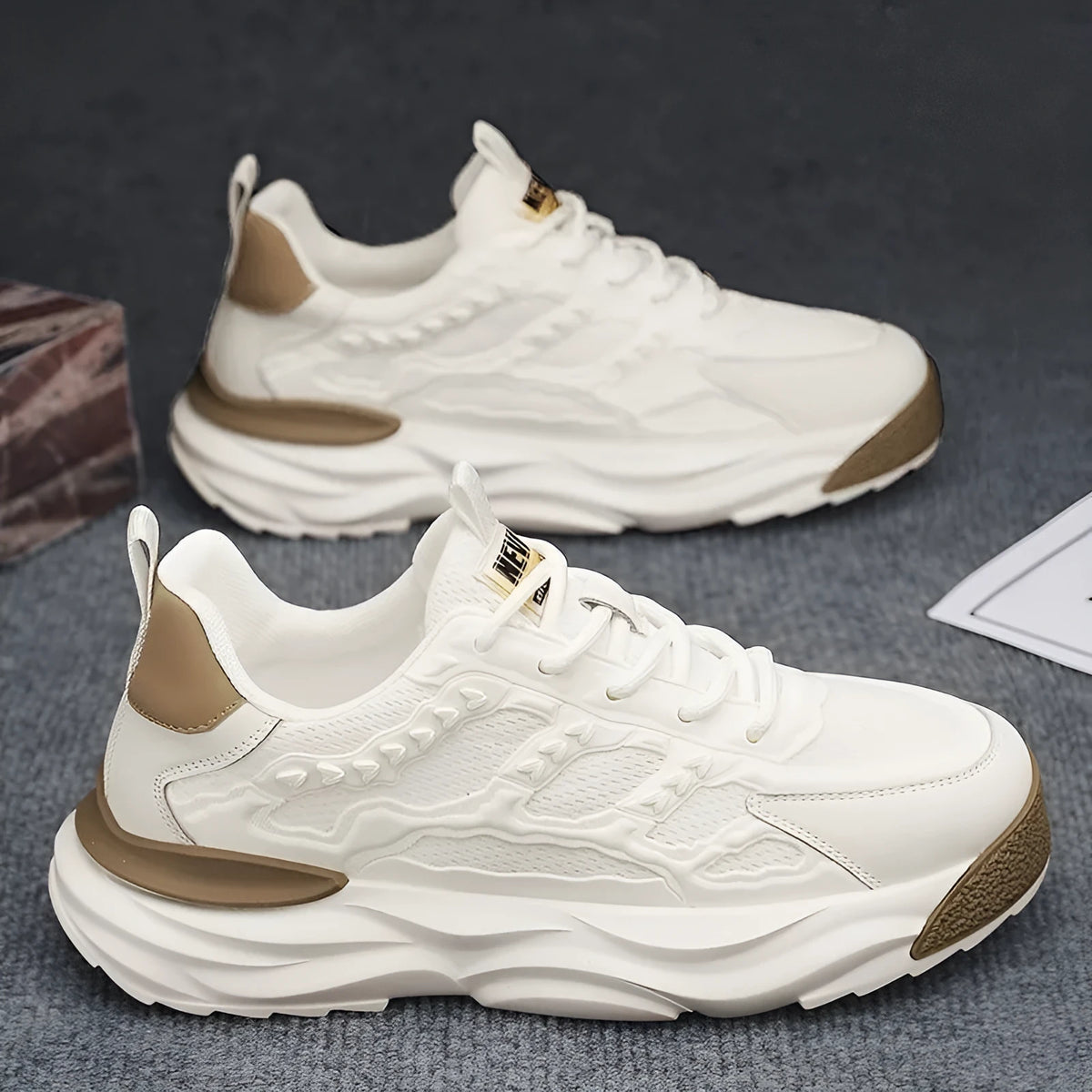 Men's solid colour breathable mesh sports shoes with round toe in white or black.