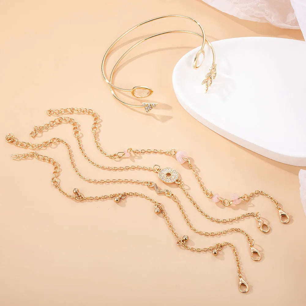 Gold tone six piece women's bracelet set with water droplet and arrow designs