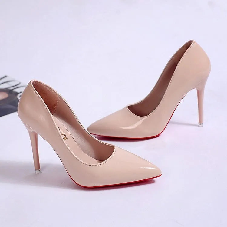 Women's black pointed toe stiletto heel pump with a low top and rubber sole.