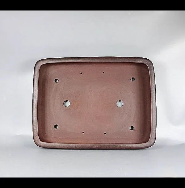 Handmade antique rectangular purple clay flower pot showing traditional ceramic texture