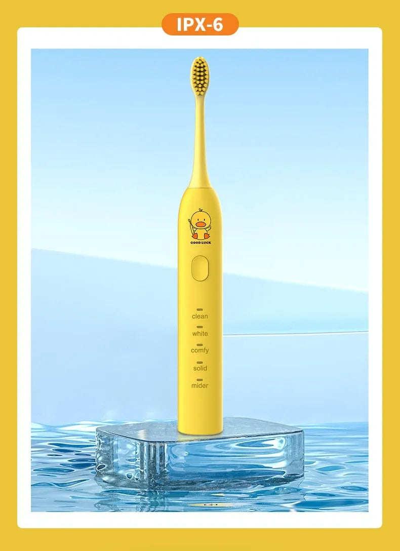 Yellow rechargeable electric toothbrush with soft bristles on a bathroom counter
