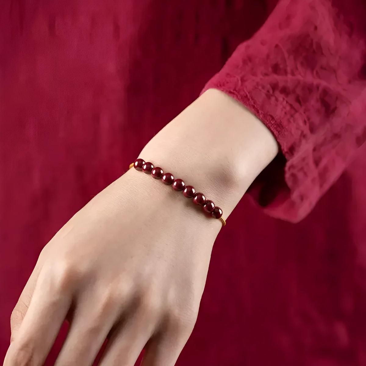 Hand-woven raw cinnabar bracelet with geometric shape on model wrist.