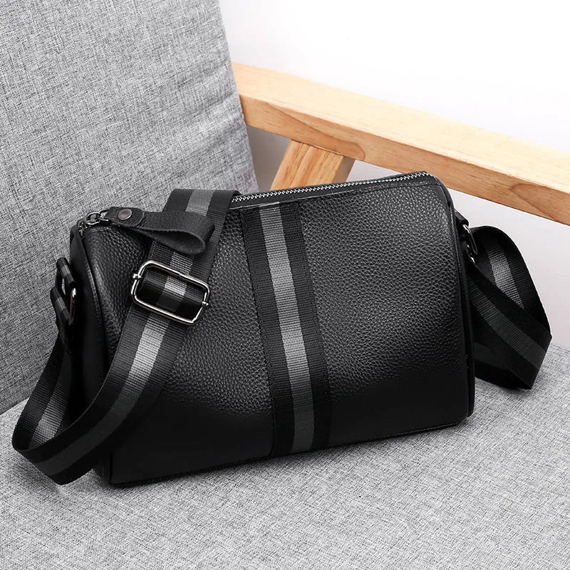 Black genuine leather one-shoulder crossbody bag showing front view and strap.