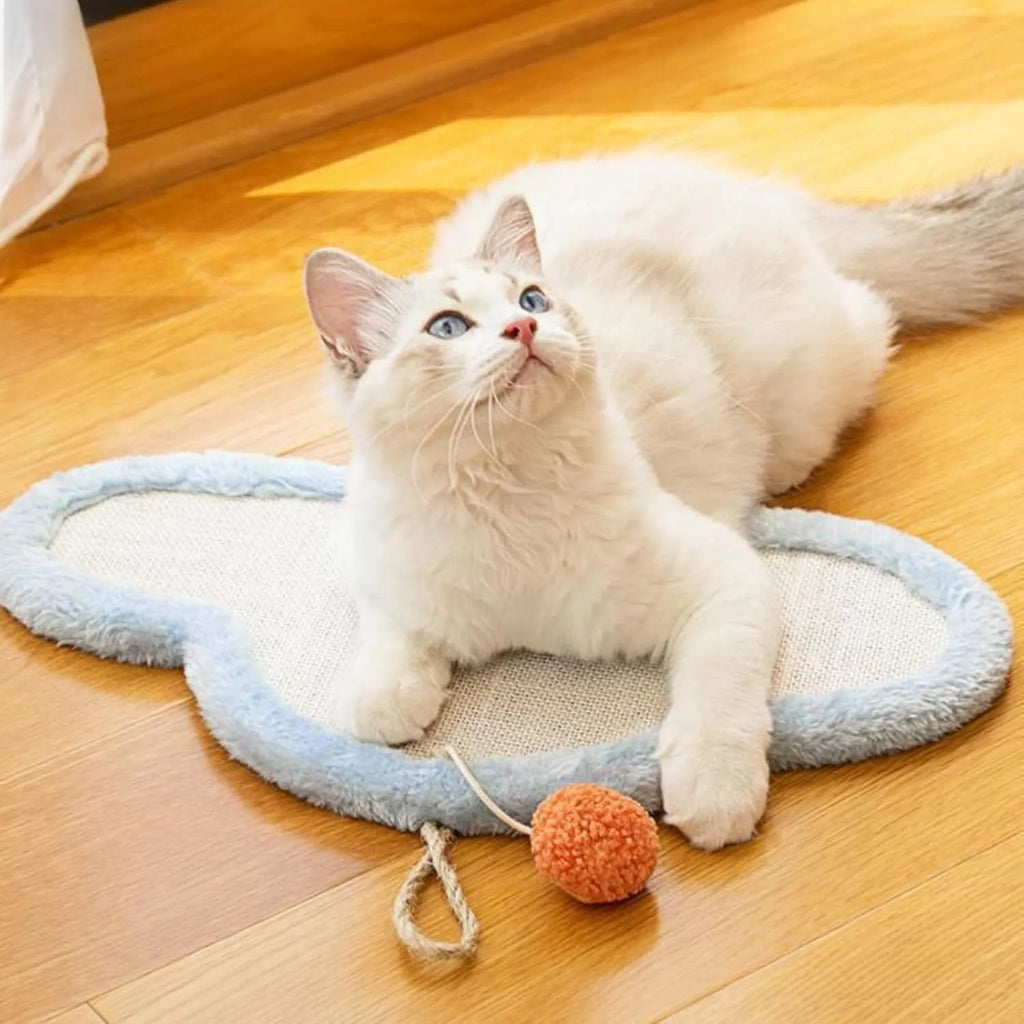 White sisal cat scratching mat with sleeping cat cartoon design mounted on a wall