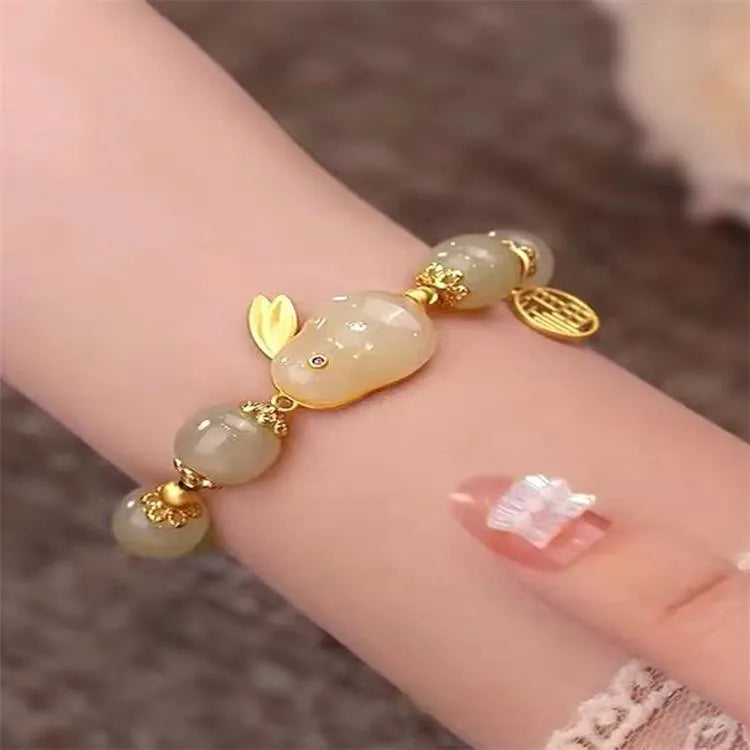 Green jade hare bracelet with black base, fu character design, and lily decorative elements