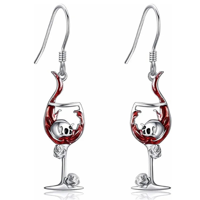 A pair of silver-toned geometric skull earrings for pierced ears on a plain background.