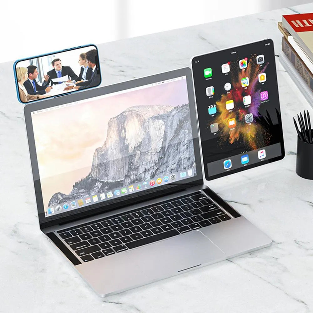 Aluminium laptop phone holder with magnetic clip mounted on laptop edge holding smartphone