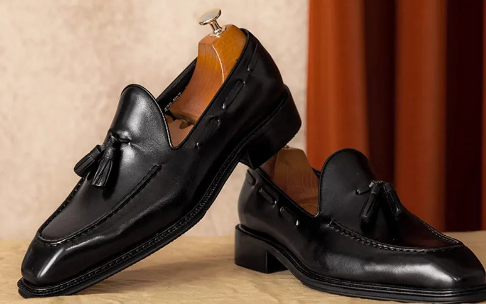 Men's black genuine leather slip-on loafers with fringed detail and rubber sole