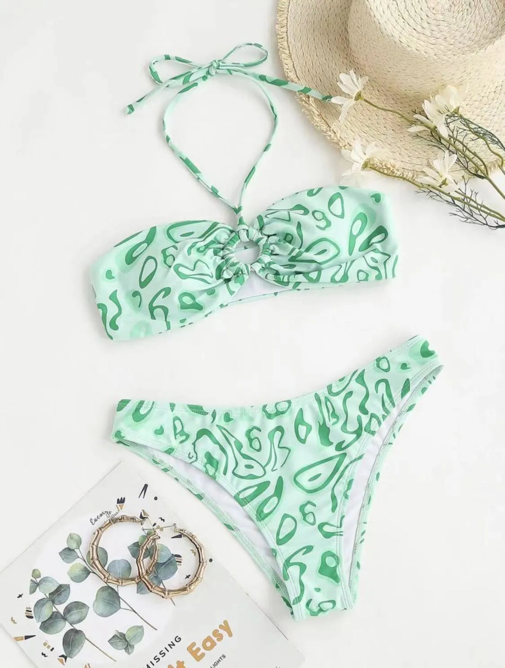 Green floral bandeau bikini swimsuit with split style bottom and backless design on mannequin