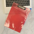Transparent A4 plate holder with metal clip, shown in blue, acting as a writing board and document folder.