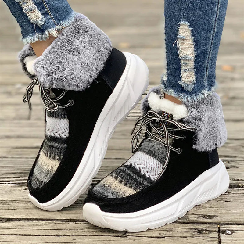 Women's beige lace-up snow boots with thermal lining and rubber sole on wooden surface