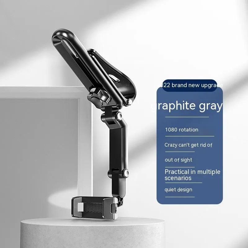 Grey single-clip car phone holder mounted on a car dashboard holding a mobile phone.