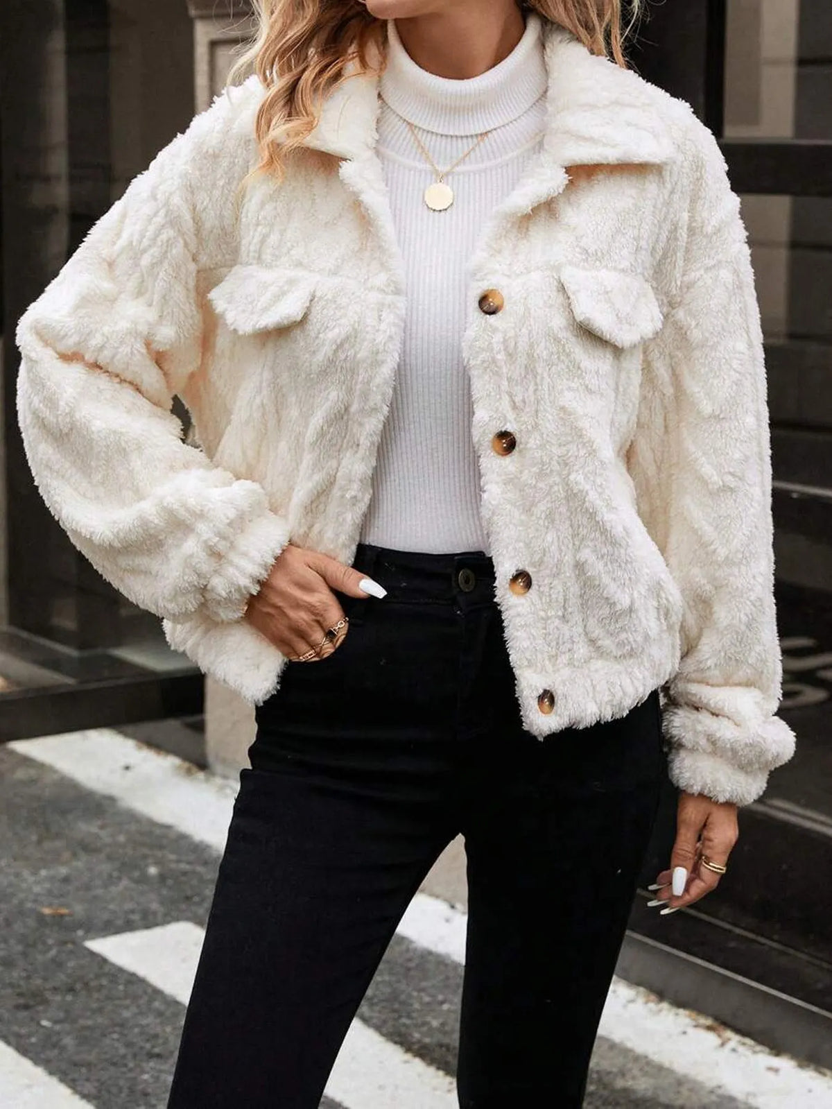 Ivory White women's plush button-front cardigan on a hanger