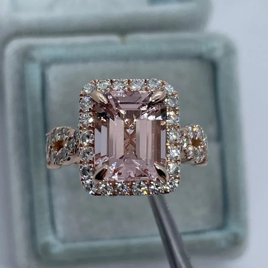 Geometric-shaped alloy ring with a rose gold electroplated finish on a neutral background.