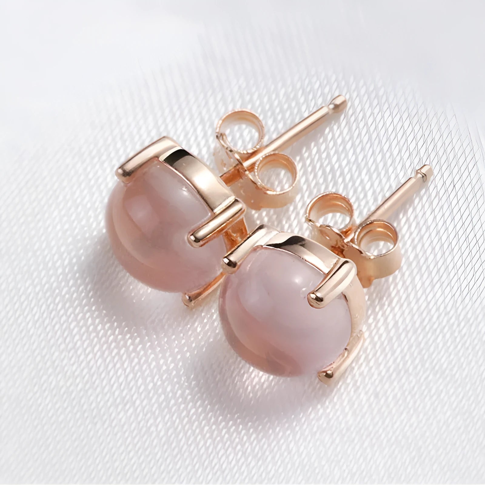 Rose gold drop-shaped stud earrings with synthetic ross quartz crystal inlay