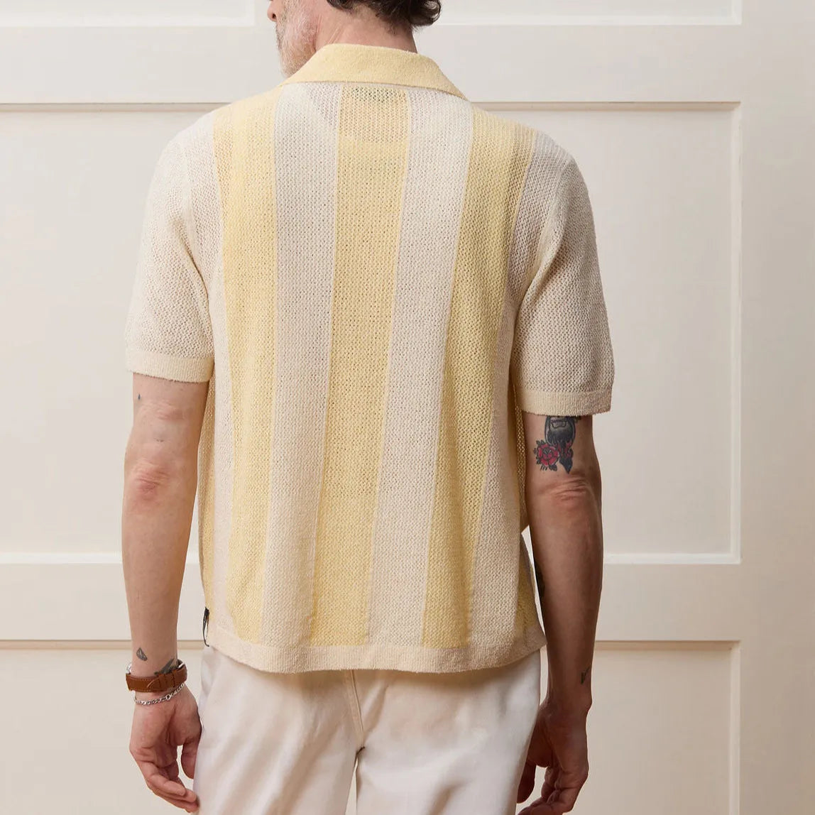 Yellow casual polo shirt with hollow-out pattern and asymmetric design detail, short sleeves