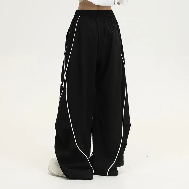Black pleated wide-leg hip hop sports trousers with a stripe pattern on a mannequin