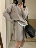 Women's milk blue casual knitted sweater and shorts suit with animal pattern embroidery.