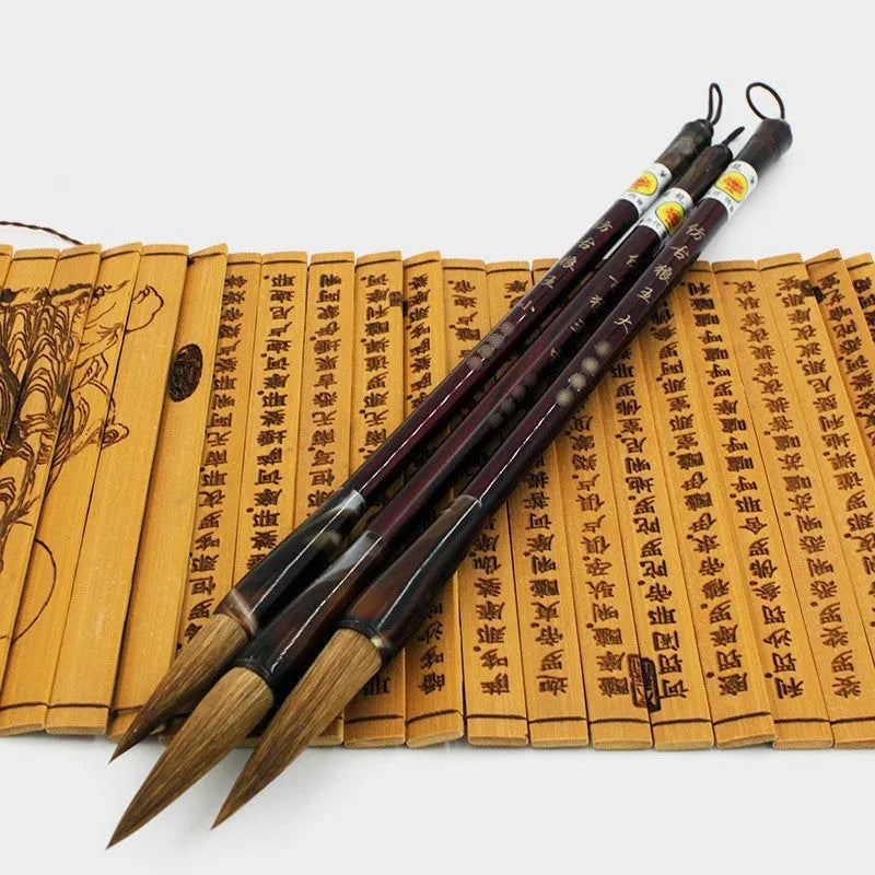 Traditional wolf hair calligraphy brush with steel rod handle in large, medium, and small sizes.