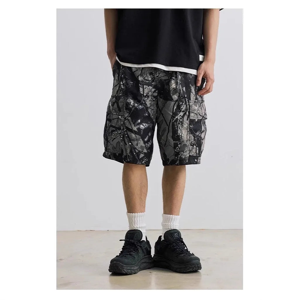 Army green loose fit straight-leg denim shorts with a mid waist and zip fly on a hanger.