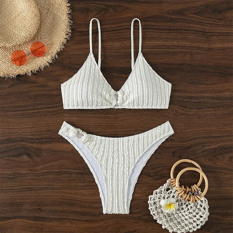 White women's V-neck sleeveless swim top with matching split beach shorts.