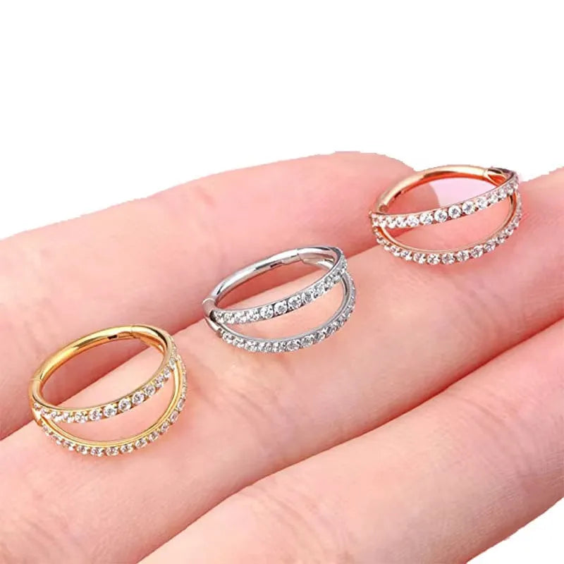G23 titanium alloy lip and nose ring with diamond-like zircon treatment in gold or steel colour on a white background.