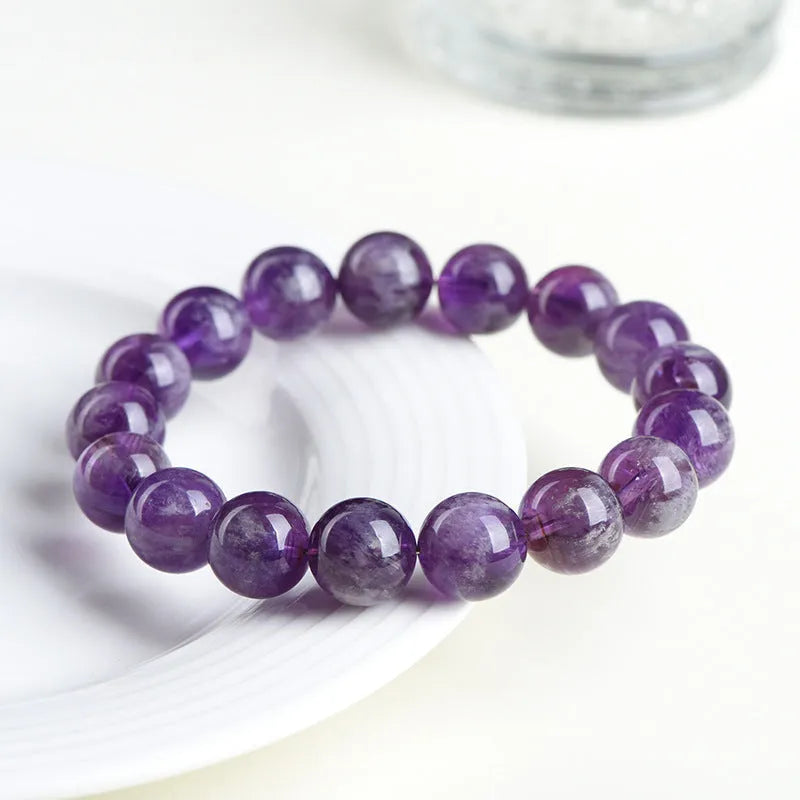 Natural feather amethyst crystal bracelet with scattered beads and Ruyi element on wrist.