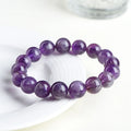 Natural feather amethyst crystal bracelet with scattered beads and Ruyi element on wrist.