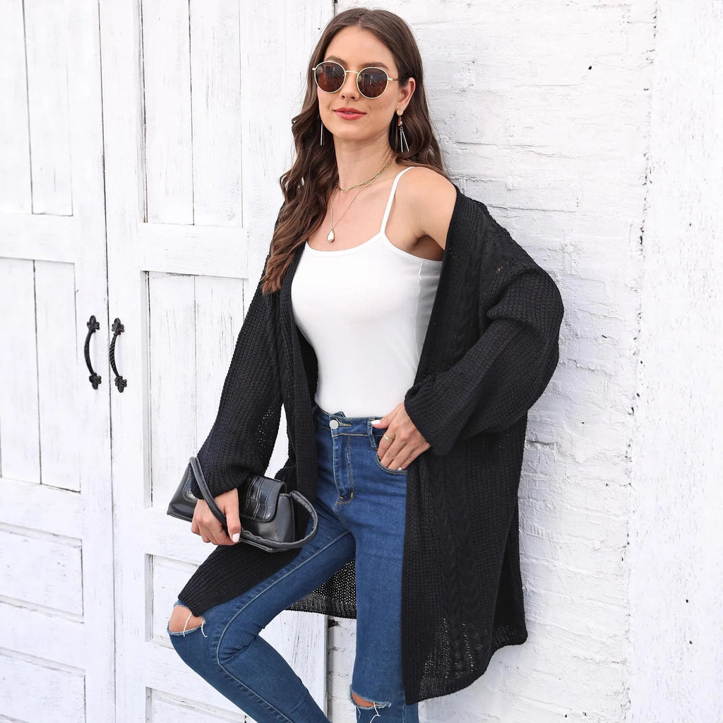 Women's loose fit acrylic sweater coat in a solid colour, shown in a casual setting.