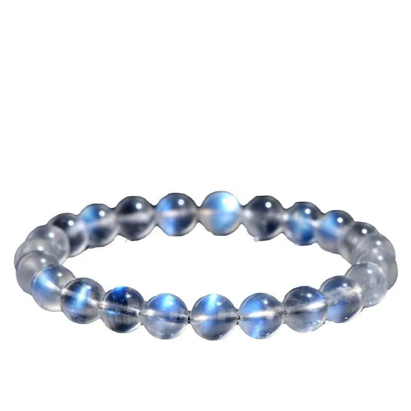 Natural blue moonlight crystal bracelet with smooth beads on a plain background.